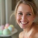 Emily smiling with bath bombs visible on vanity