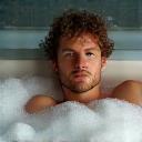 Victor relaxing in tub with bubbles
